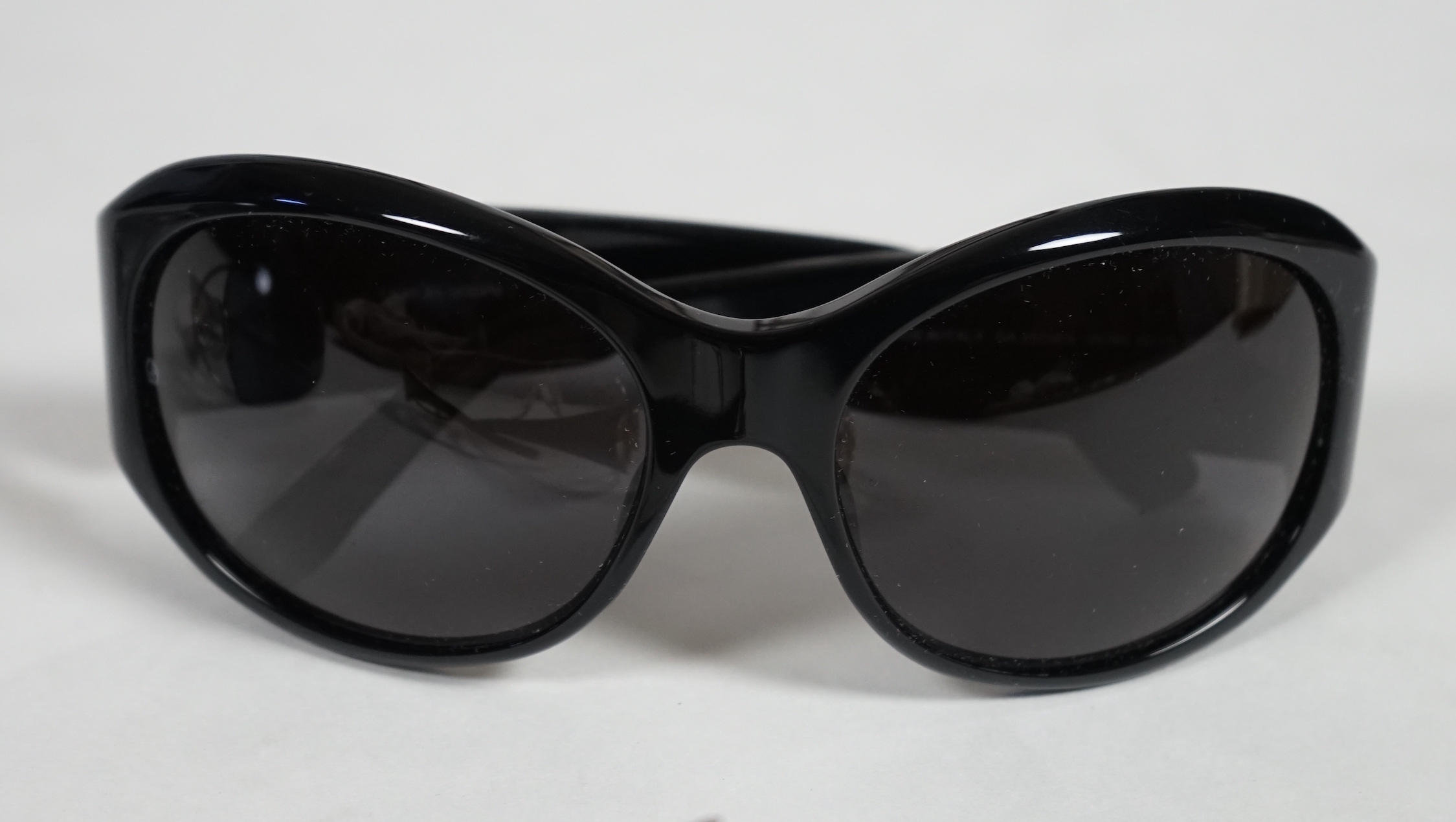 Three pairs of lady's Giorgio Armani sunglasses with cases and dust bags.